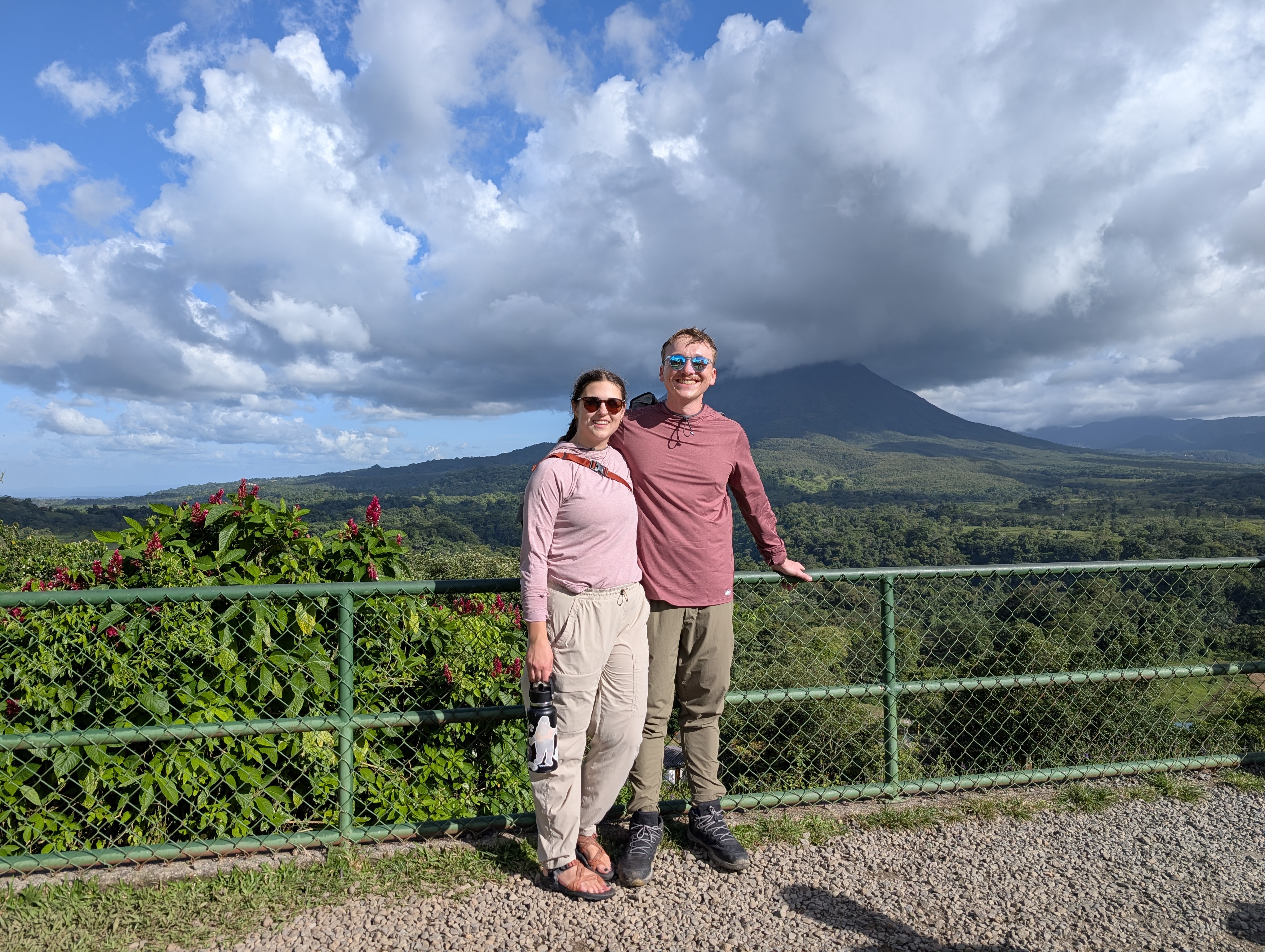 Colin and Greta in front of a cloud-shrouded volcano in Costa Rica